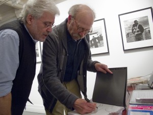 Ken Light signs a book for Robert Pledge, founder of Contact Press Images, at Ken's opening at Umbrage Books. Courtesy, ©Suzie Katz 2012