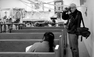 Ken Light in a church photographing the Posada (a Latin American Christmas Festival) in Toneyville during the creation of Valley of Shadows and Dreams. Photo by Allison Light. Courtesy, Ken Light 2007
