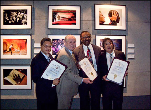 The three LA Times photographers, Genaro Molina, Kirk McCoy and Laurence Ho, display awards for their work in photojournalism. Courtesy © Susan Katz, 2009