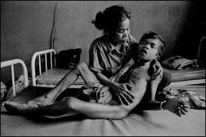 A boy experiencing severe pain from TB meningitis is comforted by his mother at Svay Rieng Provincial Hospital, Cambodia. Family members provide much of the personal care at hospitals in the developing world, courtesy © James Nachtwey, 2008.